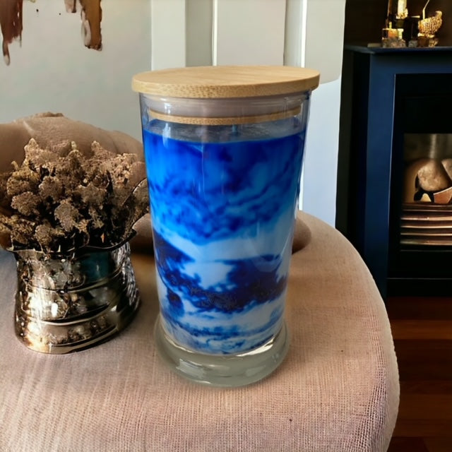 "Playing in the Rain" scented marbled candle by Owl Creek Candles. A unique, hand-poured soy wax candle with a beautiful marbled design. The candle features refreshing notes of rainwater, dewy greens, and hints of floral sweetness. Perfect for adding a touch of elegance and tranquility to any space.